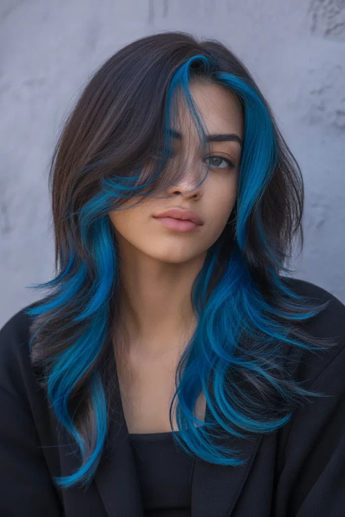 24. Layered Emo Hair with Blue Highlights